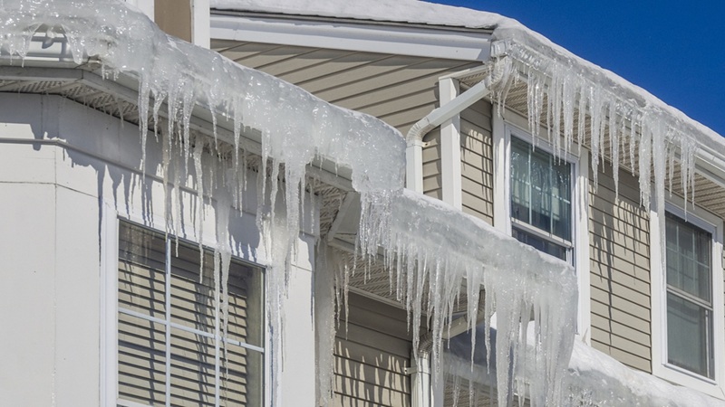 Ice Dams And Snow On Roof And Gutters