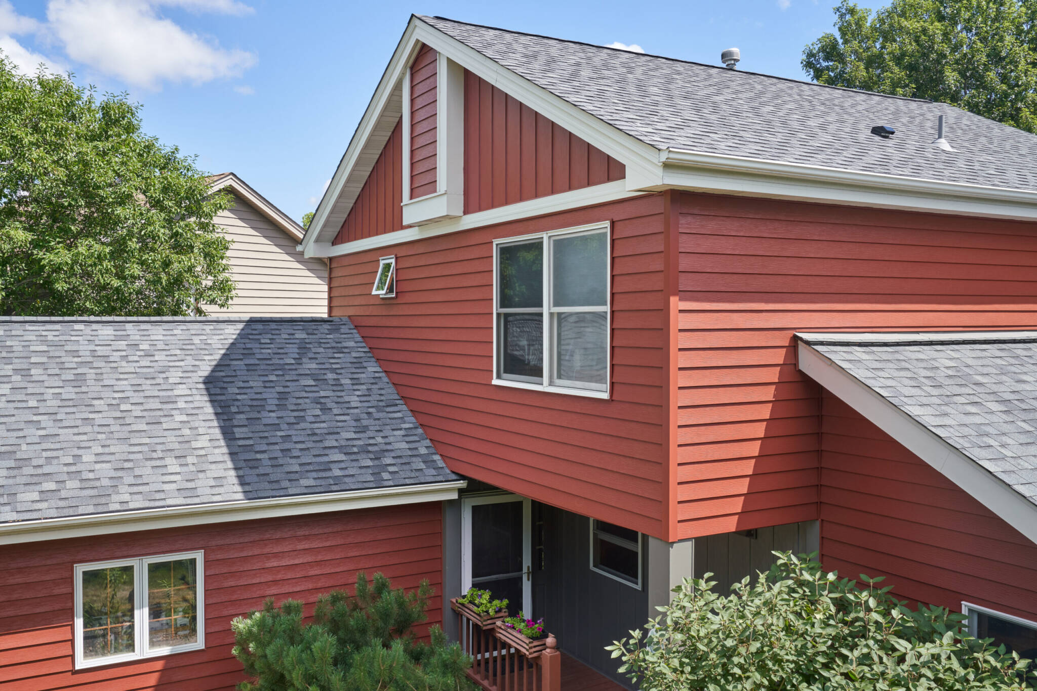 red fiber cement siding on family home