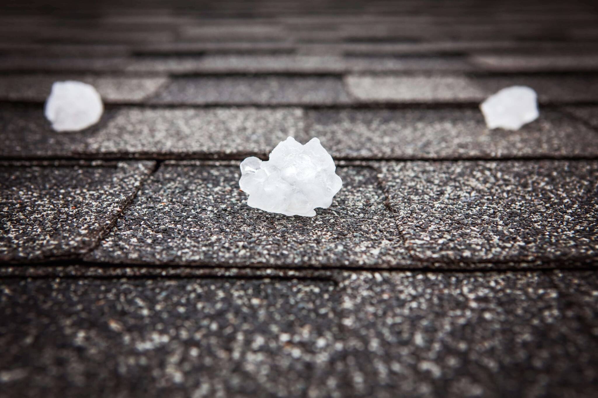 Scattered hailstones captured on a rooftop after a recent storm.
