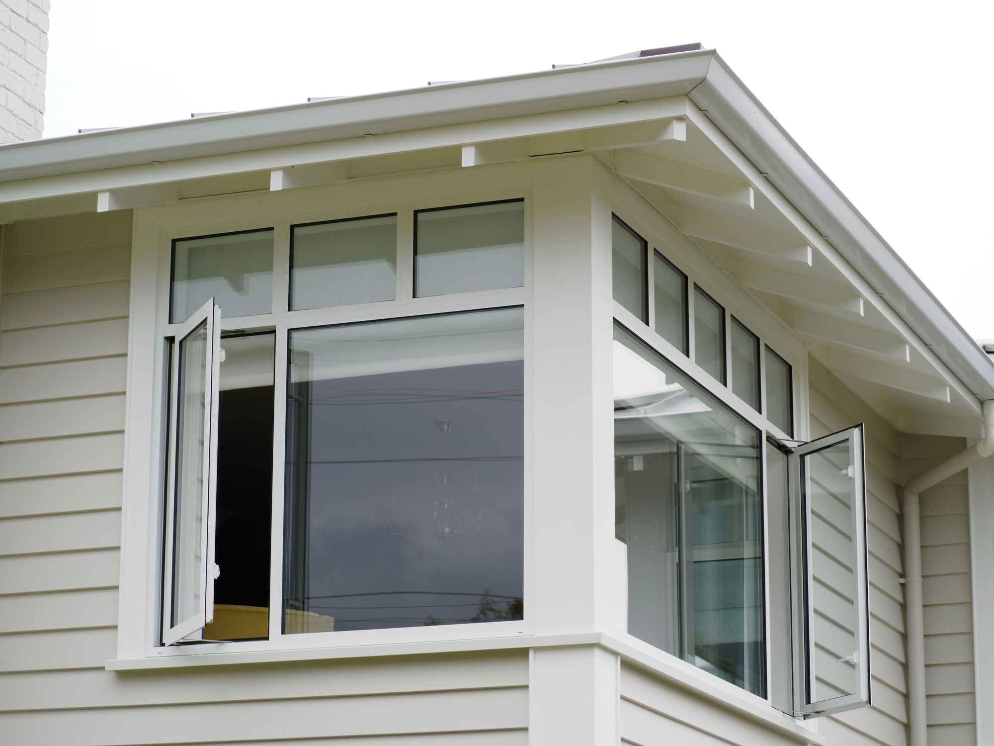 side hung casement windows and picture windows on home