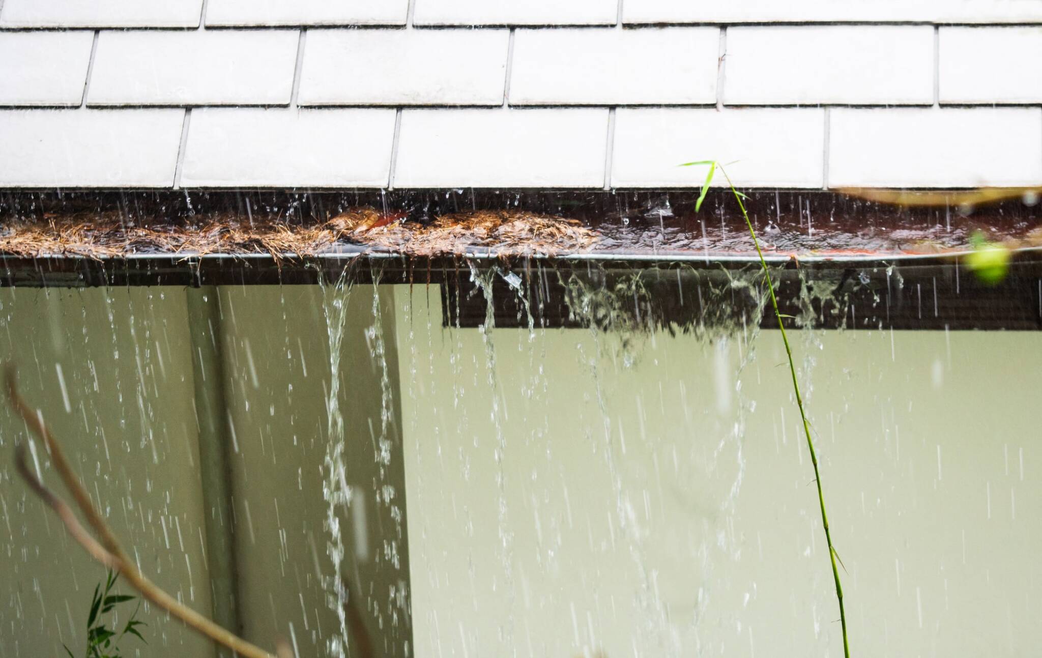 Gutters overflowing with water due to clog