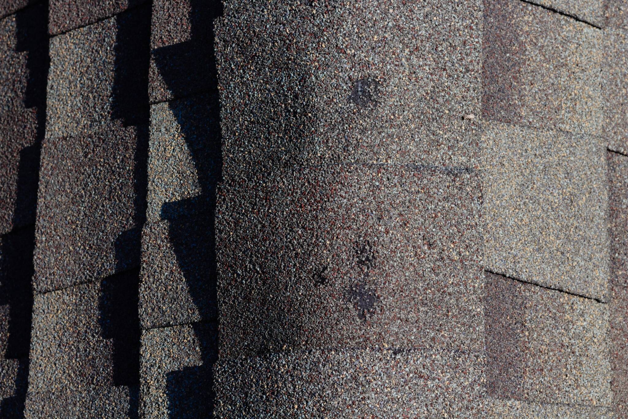 Asphalt roofing with hail damage