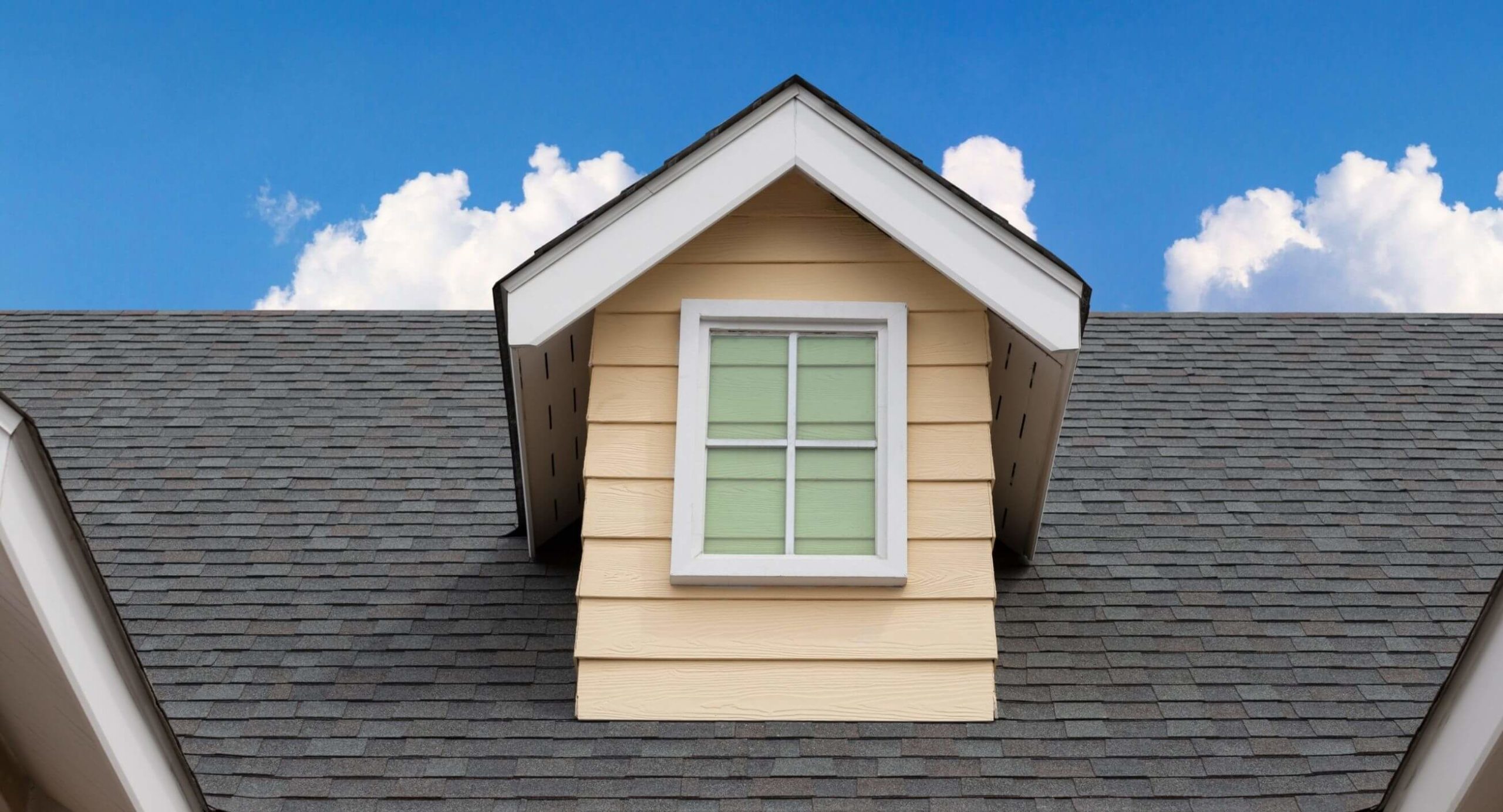 Attic pop out window surrounded by new shingles