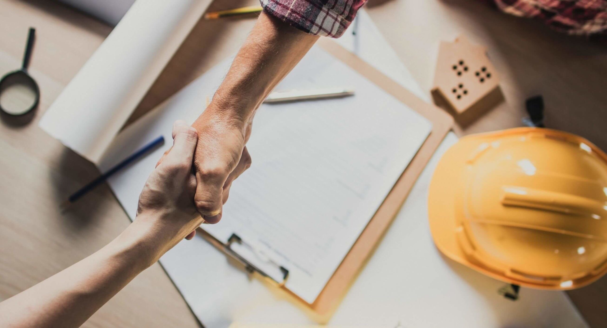 Handshake closing a deal on new shingles