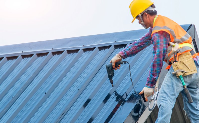 Contractor completing metal roofing installation on rooftop