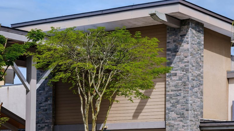 A home exterior displaying the realistic masonry appearance of Manufactured Stone Veneer.