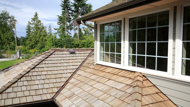 A close-up view of a cedar shake roof, showing natural wood options among types of shingles.